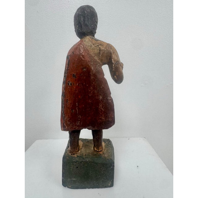 A wonderfully aged hand-carved wooden Santos figure, likely dating to the 18th or 19th century. The figure retains traces...
