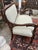 Lovely Edwardian small size mahogany loveseat having new neutral upholstery and brass casters. Gorgeous carving on arms...