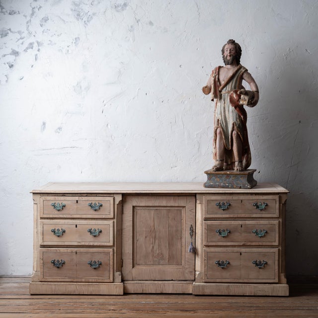 An English bleached dresser with patinated brasses. Reworked from early 19th century component parts in the mid-20th...