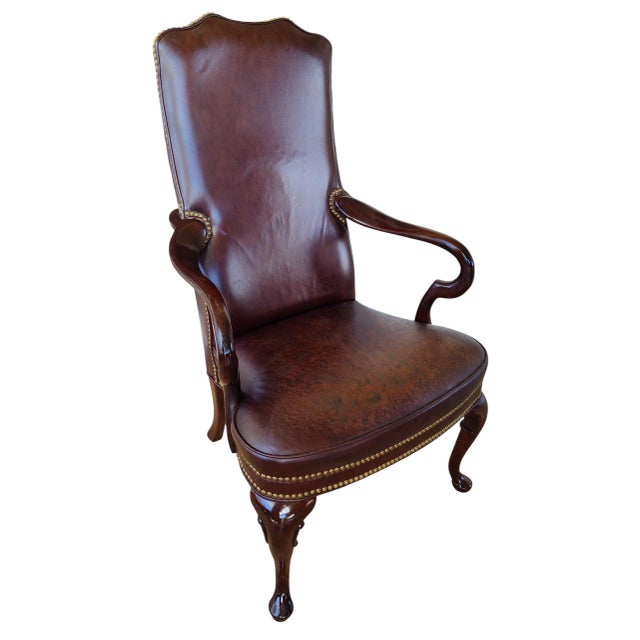 Beautifully restored vintage open-arm chair featuring rich mahogany wood and supple, restored leather upholstery. The...