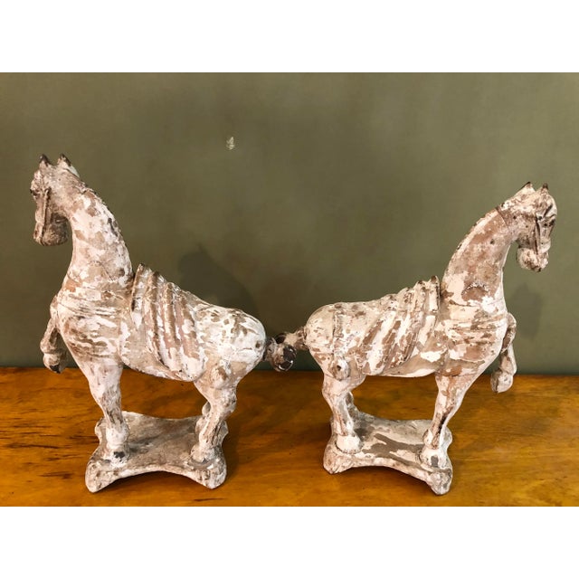 Pair of Chinese Tang Horses In old white paint. Retains old China stamp on the underneath.