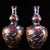 This striking pair of double-gourd vases is crafted from a bronze body and richly decorated with cloisonné enamel. Each...