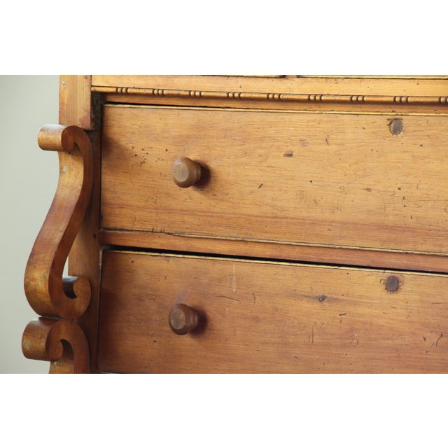 A solid pine commode from the early 19th century. Built with a strong, honest construction and a generous scale. The deep...