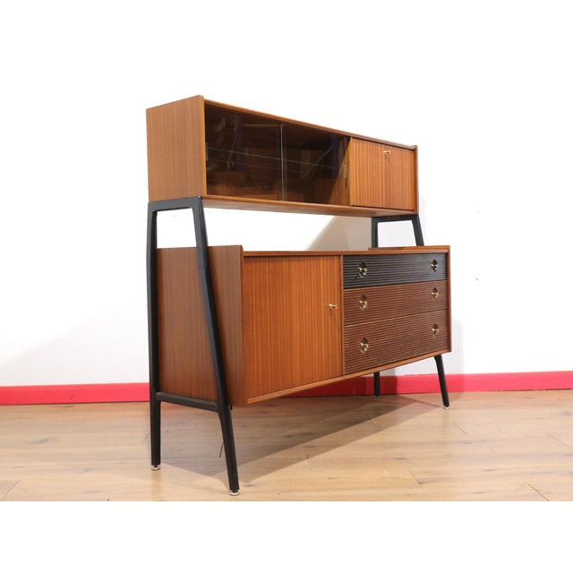 A stunning cabinet made by British furniture maker Nathan in the 1960s, this Mid Century Modern Vintage Teak Afromosia...