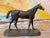 A well-modeled small cast bronze horse standing at rest on an oval naturalistic base, with good dark patina throughout....