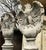 An impressive and highly decorative pair of large eagle sculptures, each dramatically modelled with powerful proportions...