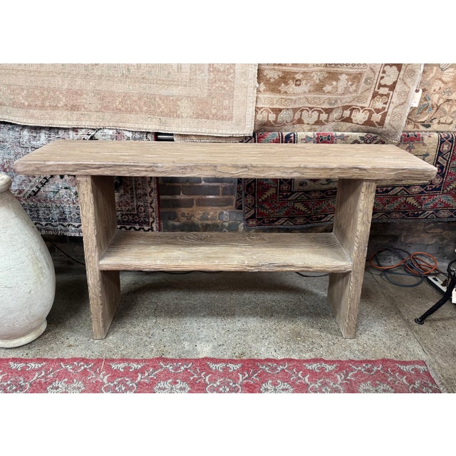 Made of asian hardwood, this two-tier console table features a deeply textured, weathered finish that emphasizes the...