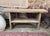 Made of asian hardwood, this two-tier console table features a deeply textured, weathered finish that emphasizes the...