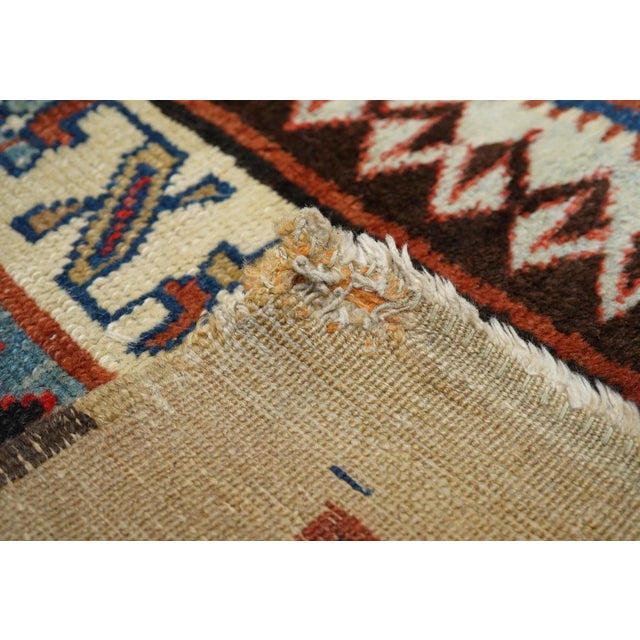 In the Caucasian Talish mode with a narrow madder field displaying a short pole medallion and two ivory ashiks. Abrashed...