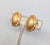 1980s goldtone oval domed with checkerboard pattern with a wrapped edge design clip earrings. Marked "Monet ©" on the...