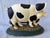 Sweet, vintage cast iron happy, black and white spotted pig doorstop. Heavy. No marks. Some minor surface wear consistent...
