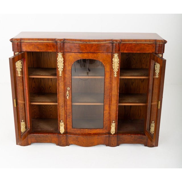 Superb quality Victorian burr walnut credenza. Beautifully figured burr walnut veneers throughout Shaped top displaying...