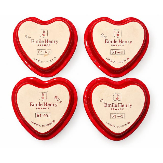 Charming set of four Émile Henry heart-shaped ceramic baking dishes, handcrafted in France. Each dish features a glossy...