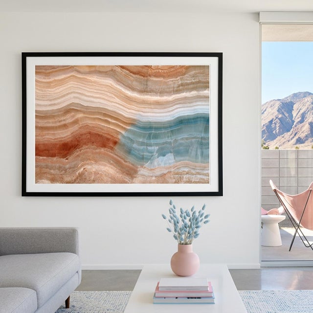 Layered mineral formations flow across the surface like an ancient geological landscape, combining warm terracotta, sand,...