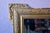 Here's a beveled antique mirror with undeniable flair! The stuccoed wooden frame, adorned with a floral frieze and a...