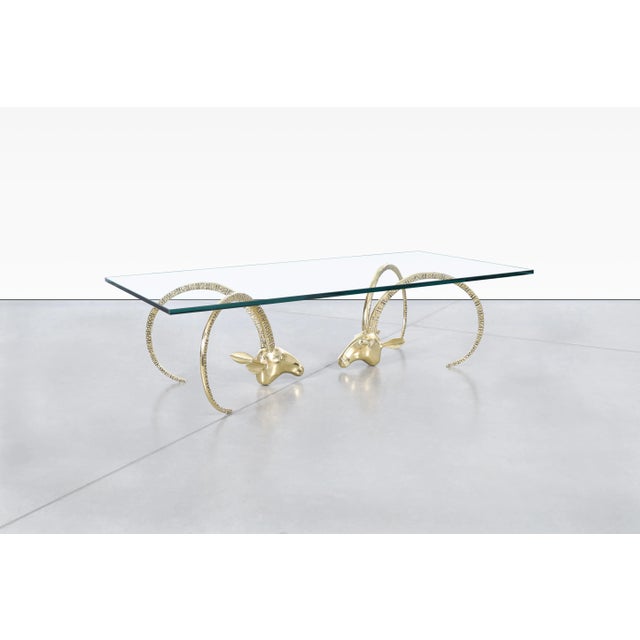 A remarkable example of sculptural design, this vintage brass coffee table transforms functional furniture into a...
