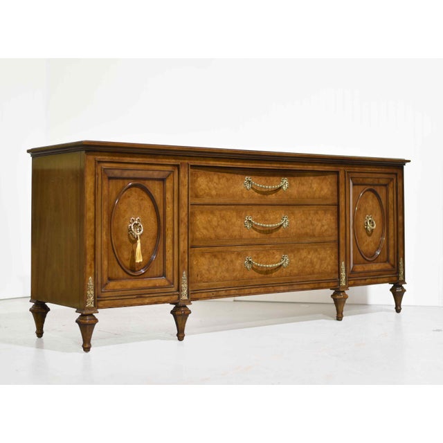 Elegant and timeless, this mid-century French Provincial–style lowboy dresser by Hellam Furniture Company showcases...