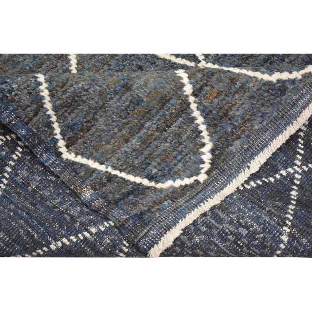 Hand-knotted with care using traditional rug making techniques, this wool rug blends timeless craftsmanship with a modern...