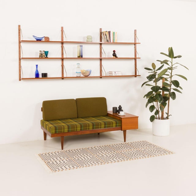 Scandinavian vintage teak shelving unit, made in the 1960s in Denmark, inspired by the iconic mid-century designs of Poul...