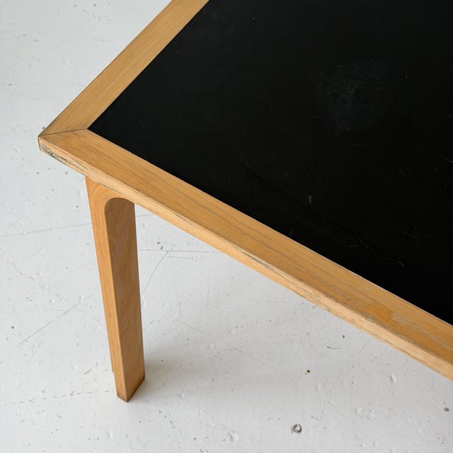 c. 1980s. Bent birch legs and inset linoleum top. Comes with connectors to join multiple tables together.