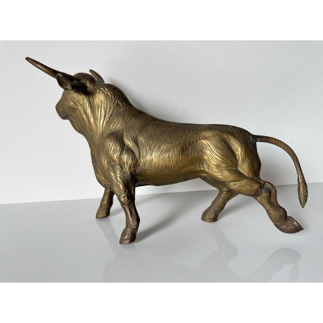 Available for sale this fantastic vintage brass sculpture of a charging bull, exuding strength and movement. The finely...