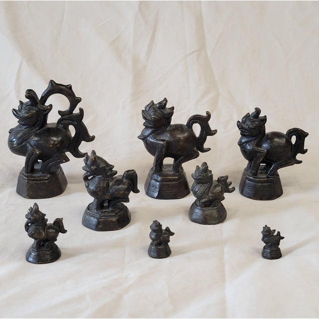 A charming set of eight antique Burmese dragon bronze opium weights. The largest weight measures4.25"H x 3.25"W x 2"D. The...