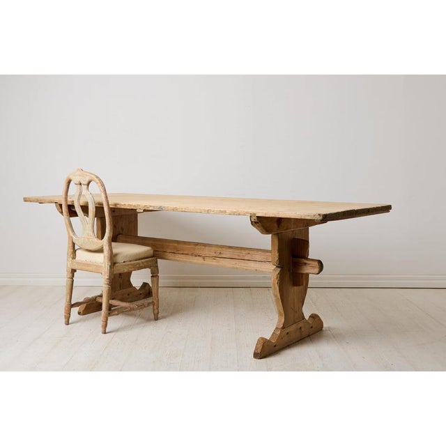 Antique country dining table made in northern Sweden. An early 19th century antique made by hand in pine around 1820 in...