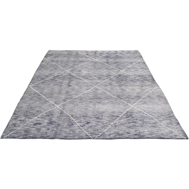 Hand-knotted with care using traditional rug making techniques, this wool rug blends timeless craftsmanship with a modern...