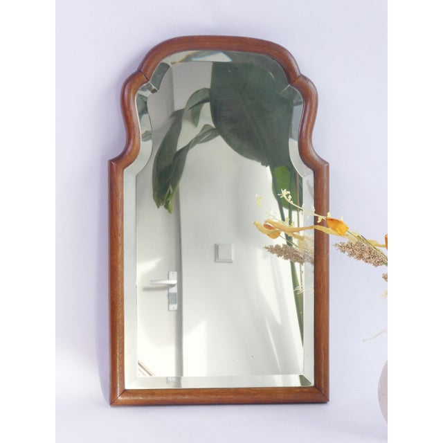 Antique wooden wall mirror with a scalloped frame and beveled mirror. The beautiful mirror features an oak frame and...