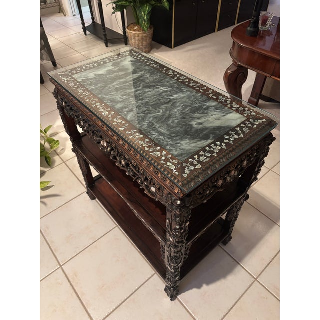 A striking and highly decorative late 19th-century Chinese export three-tier occasional table, masterfully crafted in...