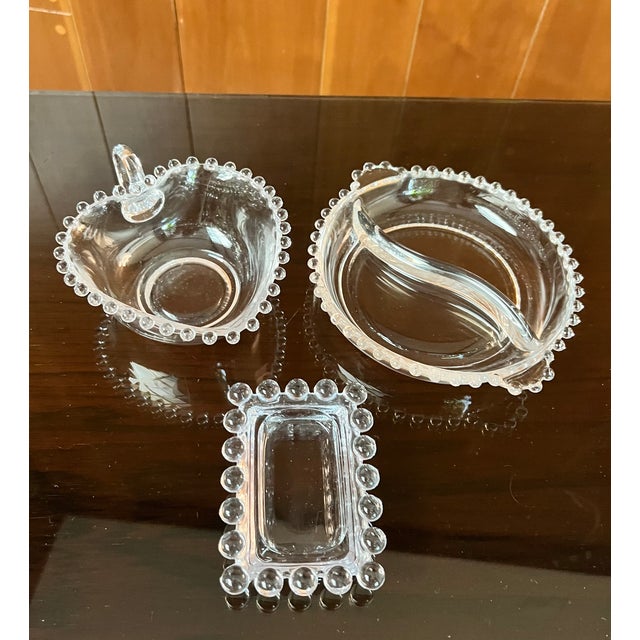 This set includes three vintage Imperial Glass “Candlewick” pieces, featuring a divided round relish dish, a heart-shaped...