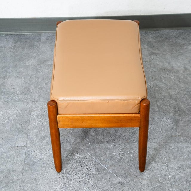 Unique 4 leg tan leather rectangular ottoman. Danish design. Stamped example. Sturdy piece.