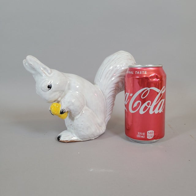 A charming vintage Italian terracotta squirrel, finished in a glossy white glaze and modeled in a sweet, naturalistic pose...
