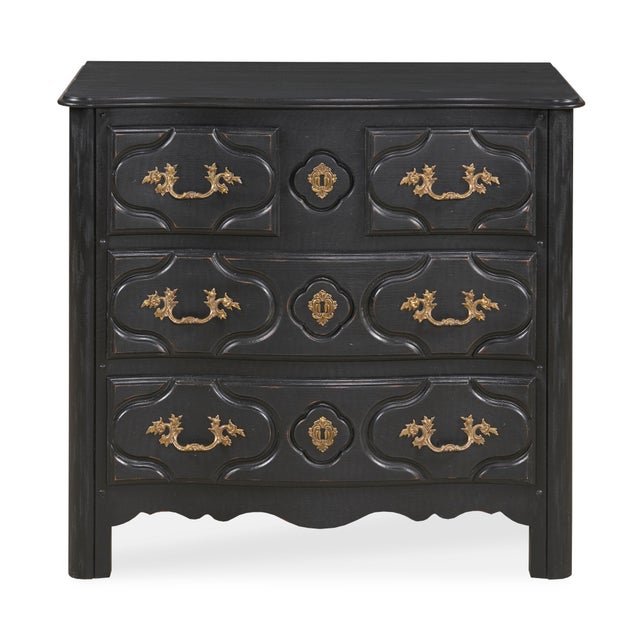 The 18th-century inspired Louis XIV ebonized three-drawer chest with elaborately detailed handles and escutcheons...