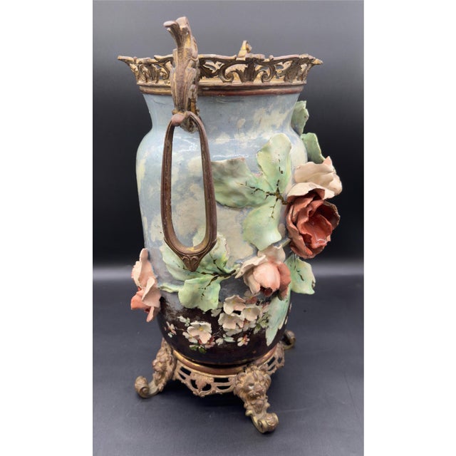This is a gorgeous 19 century French majolica vase featuring heavily adorned with large heavily adorned flowers and is...