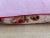 A pillow made from a circa the 1880s printed cotton with a rose bud scattered motif. A down insert is included.