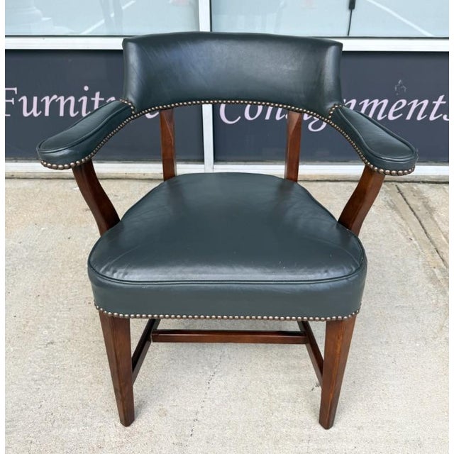 This vintage office chair by Statesville Ross features deep blue leather upholstery, a gently curved open back, padded...