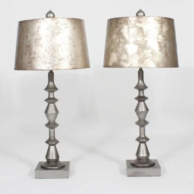 A pair of Mid-Century Modern composite geometric form lamps in silver, with silver gilt shades. Interesting geometric...