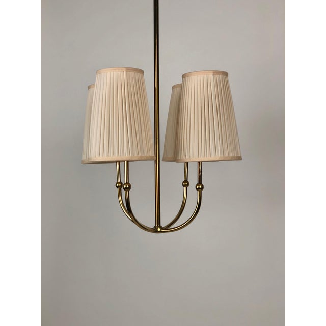 This is a beautifully proportioned brass chandelier from the 1930's, with a poetic form. I find it simply: Wow. The...