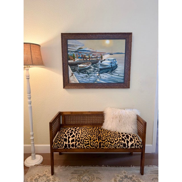 Vintage Hollywood Regency cane-back bench reupholstered in Ballard Designs’ iconic jaguar-print fabric. A chic statement...