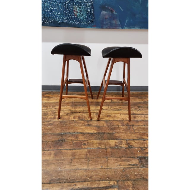 Beautiful Pair of Vintage Teak barstools by Erik Buch. leather isnin great shape. features rosewood footrests.