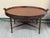 Design Plus Gallery presents an Aged Regency Coffee Table from Maitland Smith. The table has an oval shape with a medium...