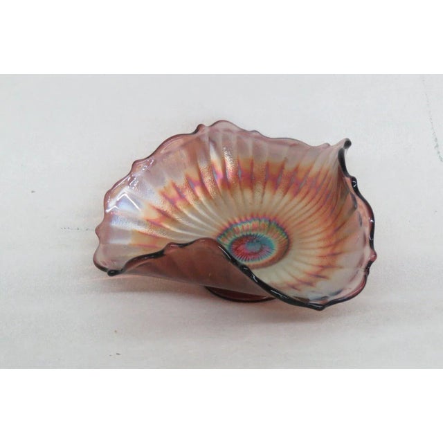 This excellent Candy Dish is made of carnival glass. This piece features the Stippled Rays pattern used by Fenton; it...