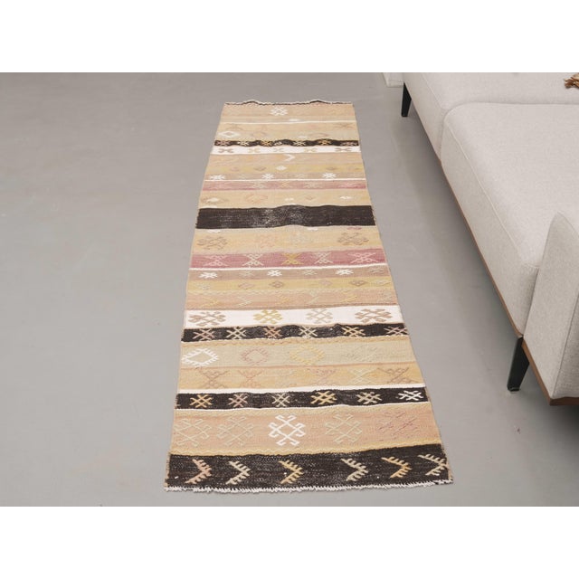 Vintage Hand-Knotted runner rug is a semi-antique vintage runner rug. The '70s Eastern region of Anatolia's unique rug is...
