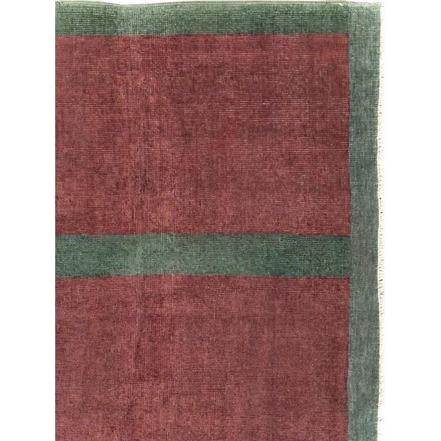 This mid-20th-century Turkish Art Deco style rug presents a bold minimalist composition of five elongated burgundy forms...