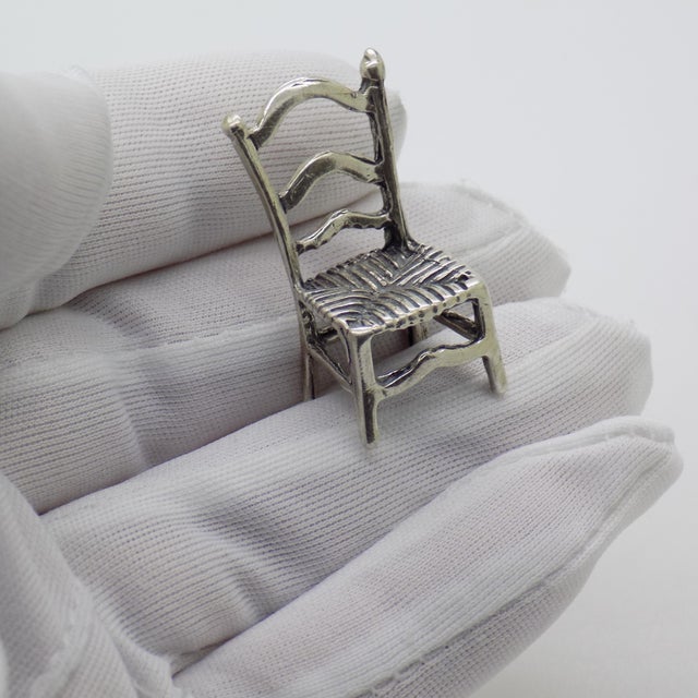 Handcrafted in Arezzo, Tuscany, during the 1970s to 1980s, this miniature chair figurine is cast in solid 800 continental...