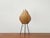 Rare mid-century table lamp with a characteristic shade shape. The striking lampshade is supported by an inner frame,...