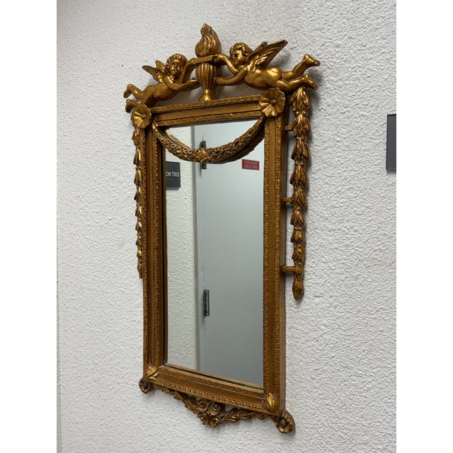 Design Plus Gallery presents a Cherubs with Festoon Wall Mirror. This charming rare 18th Century looking glass symbolizes...