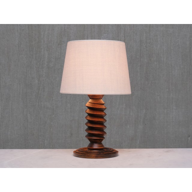This sculptural table lamp was produced in France in the 1950s. The rustic and elegant design is attributed to Charles...