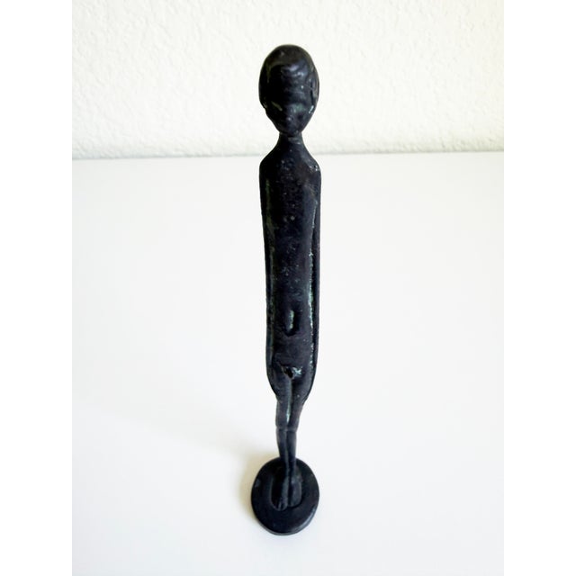 A small scale reproduction of the Etruscan bronze statuette known as the Ombra della Sera (Shadow of the Evening). It...